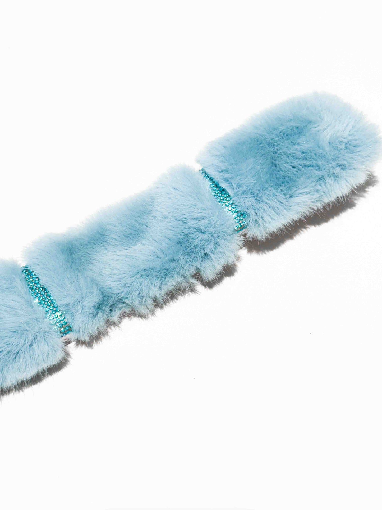 A luxurious dog collar in light blue fur with sparkling rhinestone accents, showcasing a colorful and elegant accessory for pets.