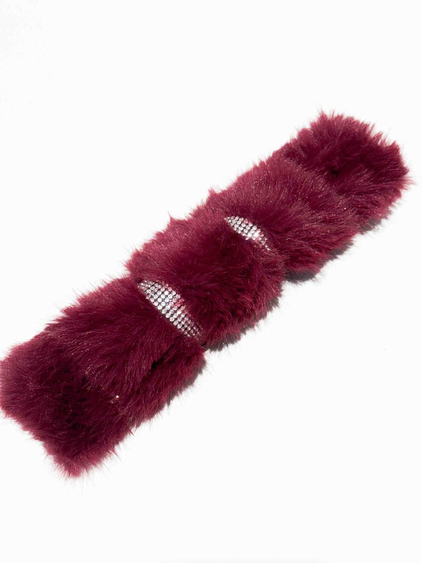 A luxurious dog collar in deep burgundy fur with sparkling rhinestone accents, showcasing a colorful and elegant accessory for pets.